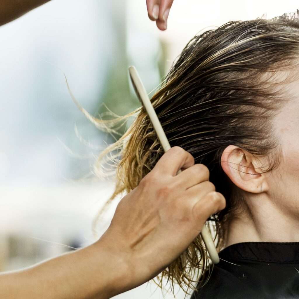 Customer getting a haircut in a beauty salon