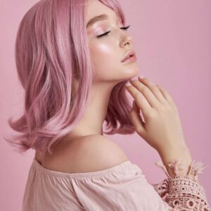 Portrait of a sexy young woman with pink hair. Perfect hairstyle and hair coloring. Girl