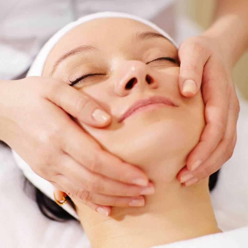 Woman in the beauty spa getting a facial massage